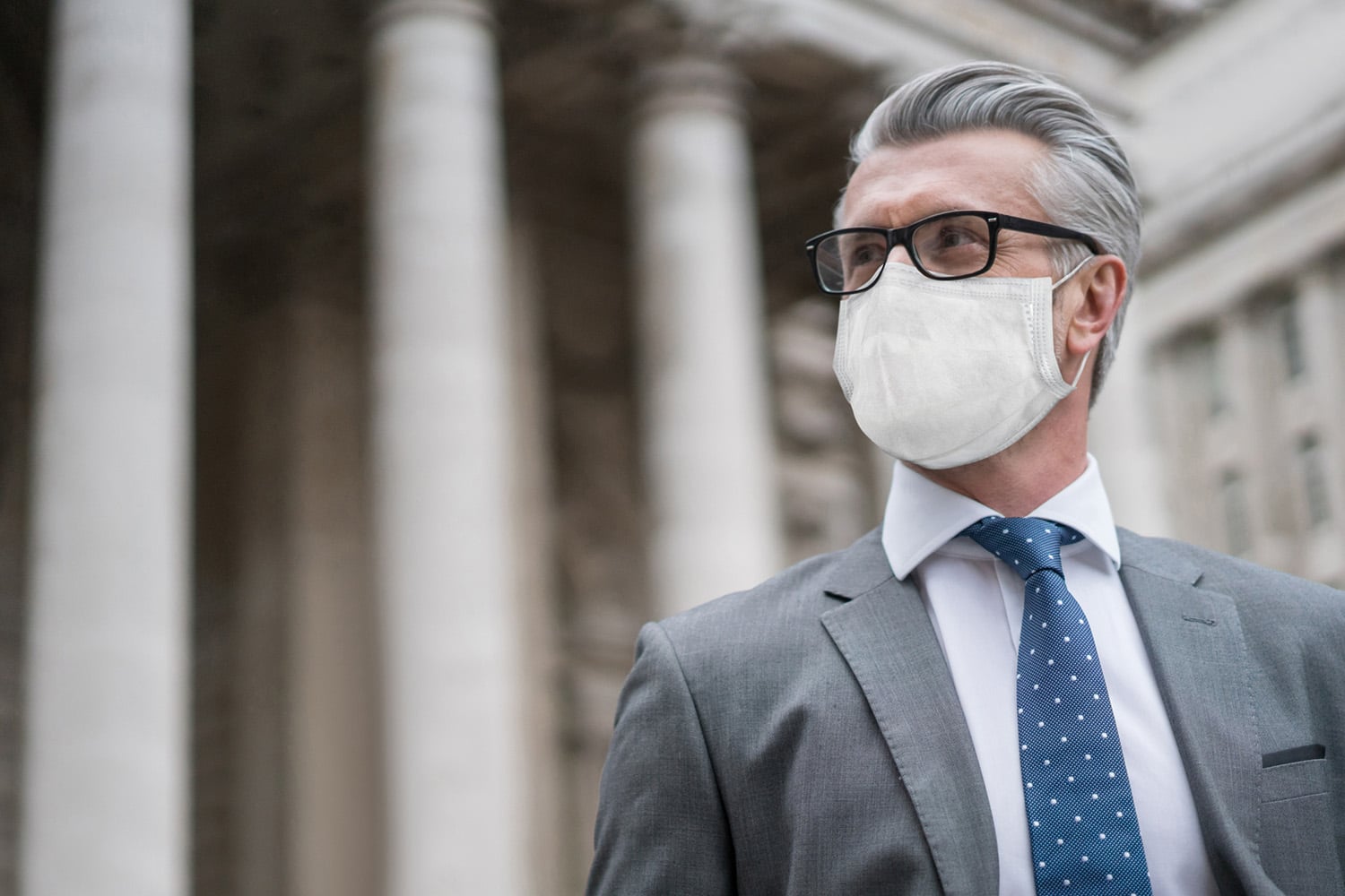 Portrait of a successful business man on the street wearing a facemask to avoid COVID-19 â Pandemic concepts